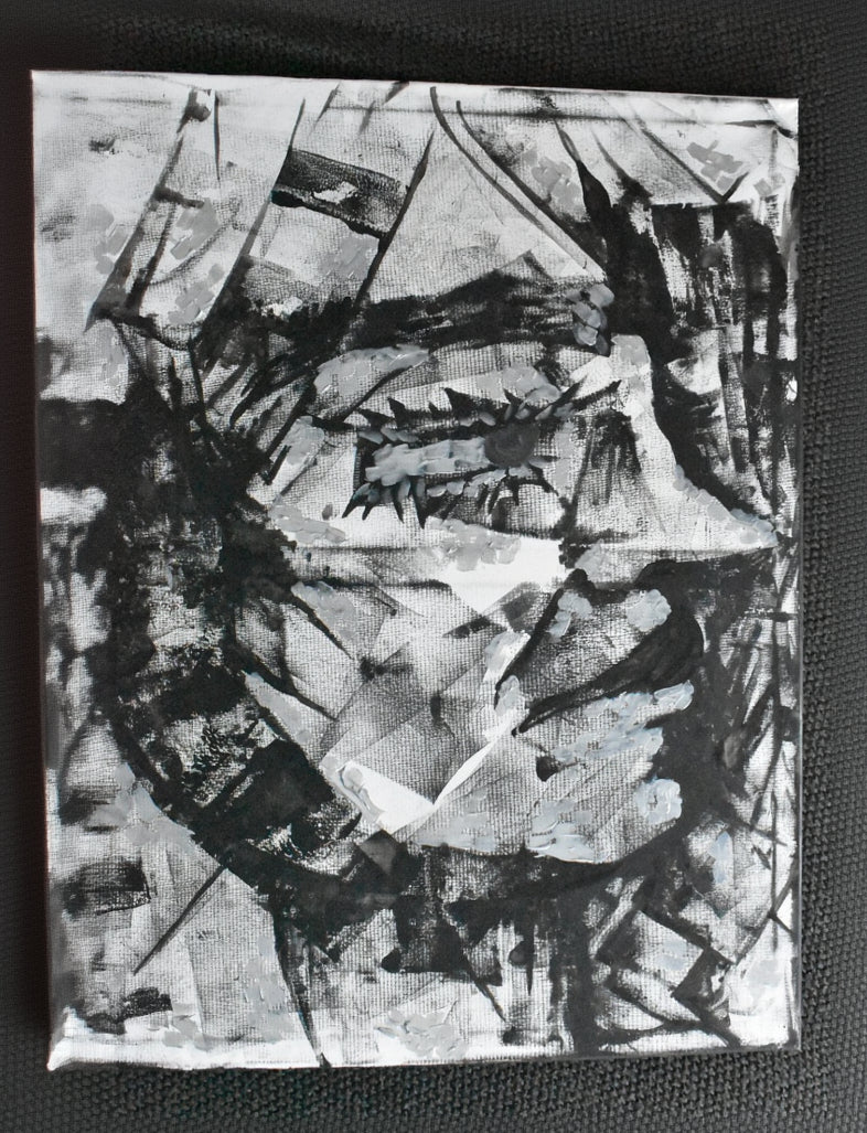 Abstract black and white artwork on a textured surface